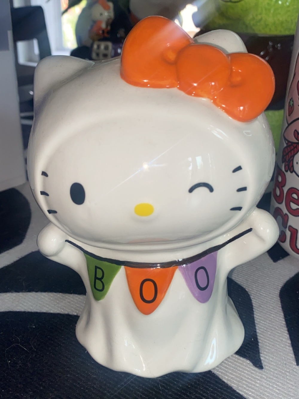 Hello Kitty White Ghost Figurine with Orange Bow and Colorful BOO Banner